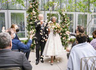 Melva and Emmanuel tied the knot in an April wedding at the Conrad Hotel in Washington, D.C., with a color palette of purple, black and green. However