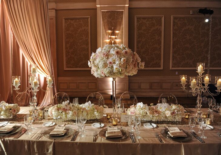 "Our reception was in the Grand Ballroom, where everything from the carpet print to the chandeliers matched the palette and vibe we wanted," Sarah says. She outfitted the Waldorf Astoria in Orlando, Florida with florals of different heights in mercury-glass vessels, along with and crystal candelabras with candlesticks that "matched perfectly with our neutral palette."