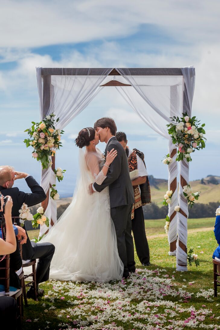 First Kiss Underneath Elegant Wedding Arch