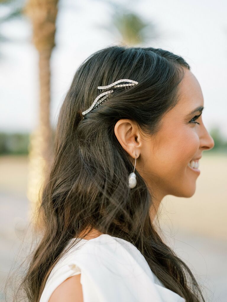 Bride wears clips bedazzled hair clips in her hair. 