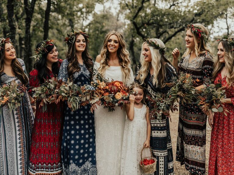 Bridesmaids wear mismatched bohemian gowns with flower crowns. 