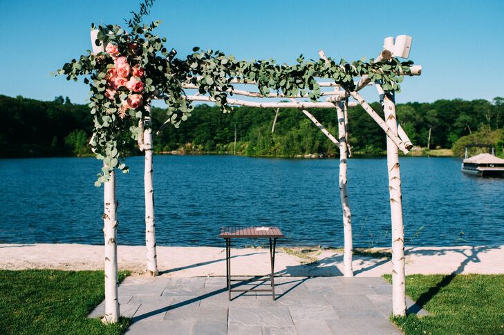 With the help of Ibranyi Is Floral, Kim and Nick used an abundance of greenery to mark their waterfront ceremony. Each post along the front of their birchwood wedding arbor overflowed with seeded, silver dollar eucalyptus and romantic pink garden roses. We love how they captured the Rock Island Lake Club’s tree-filled grounds in Sparta, New Jersey, with an organic design.