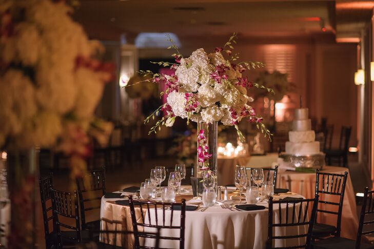 With a simple gold runner complementing the couple's metallic wedding colors, the team at Dalsimer Atlas made sure they filled the space with fun florals. Each centerpiece of floating pink orchids was met with an arrangement of white hydrangeas and more pink orchids sprouting from the top.