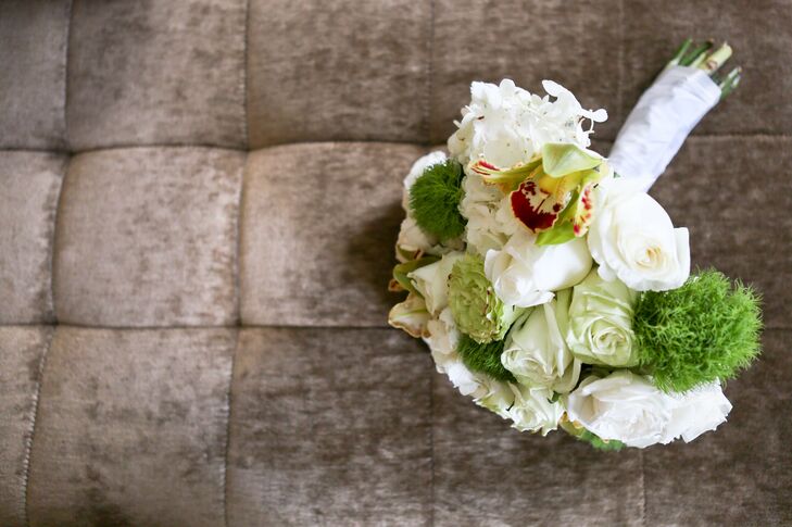 The bridal bouquet was a green and white colored arrangement of roses, hydrangeas and lilies.
