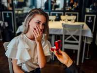woman in restuarant getting proposed to