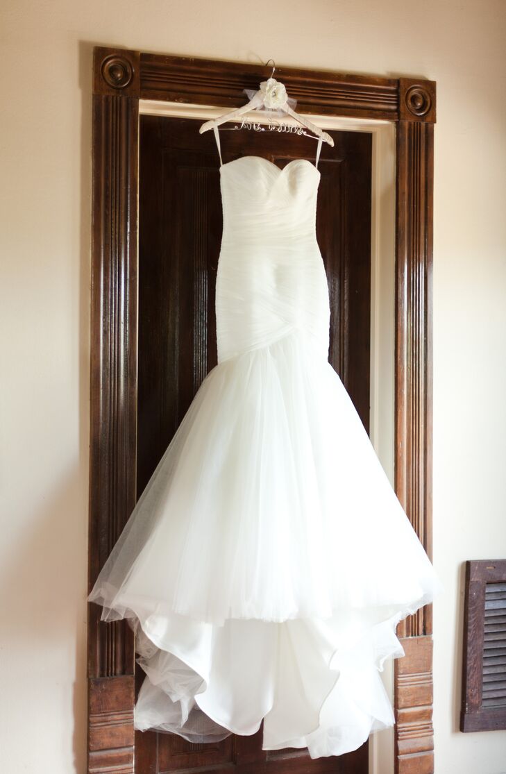 The bride wore a clean and modern mermaid style tulle dress with removable tulle straps. For the reception, Catherine added a silk belt with whimsical tulle flowers.