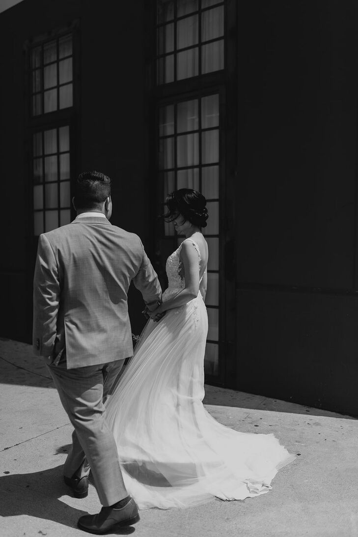 Black and White Photo of Groom and Bride Walking in Downtown LA Holding Hands