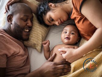 parents snuggling with baby