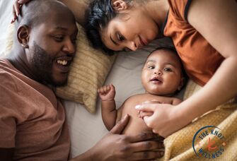 parents snuggling with baby