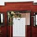 Rustic Seating Chart with Greenery Hanging from Copper Pipe Easel