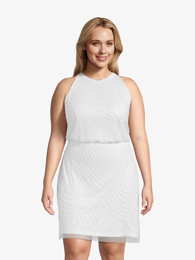 A model shows off this 1920s-inspired white beaded gown.