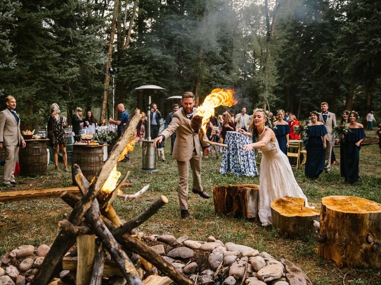 Bride and groom lighting bonfire during wedding unity ceremony