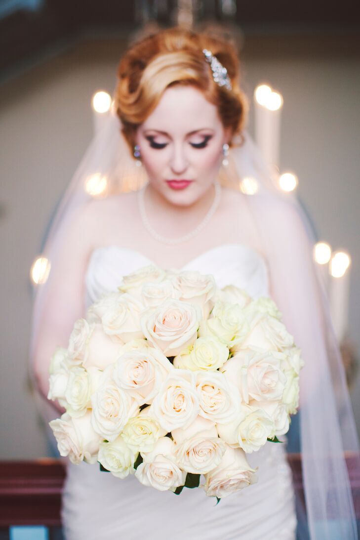 Inspired by their palette of soft blush and gold, the bride kept her bouquet simple thanks to blush and cream-colored roses.