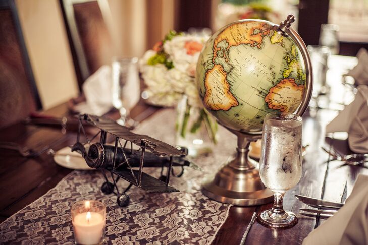 The couple chose two styles for their reception decor. “I wanted to combine romance and travel and I did this by combining floral arrangements with travel inspired center pieces,” says Lora.