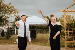 Couple Holding Red Solo Cup Shot Glasses at Backyard Reception