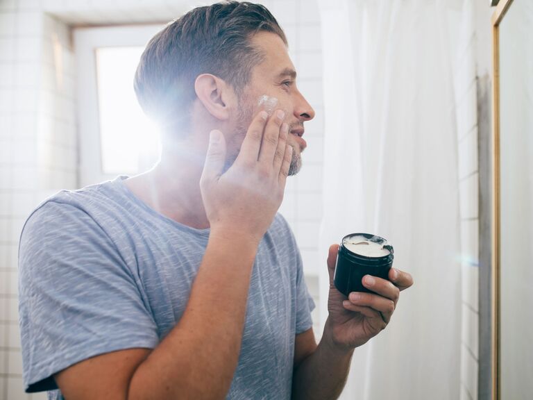 Man applying skincare product to get rid of acne