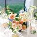Dining Table With White Linens, Low Pastel Centerpiece, Taper Candles, Blue China Saucers