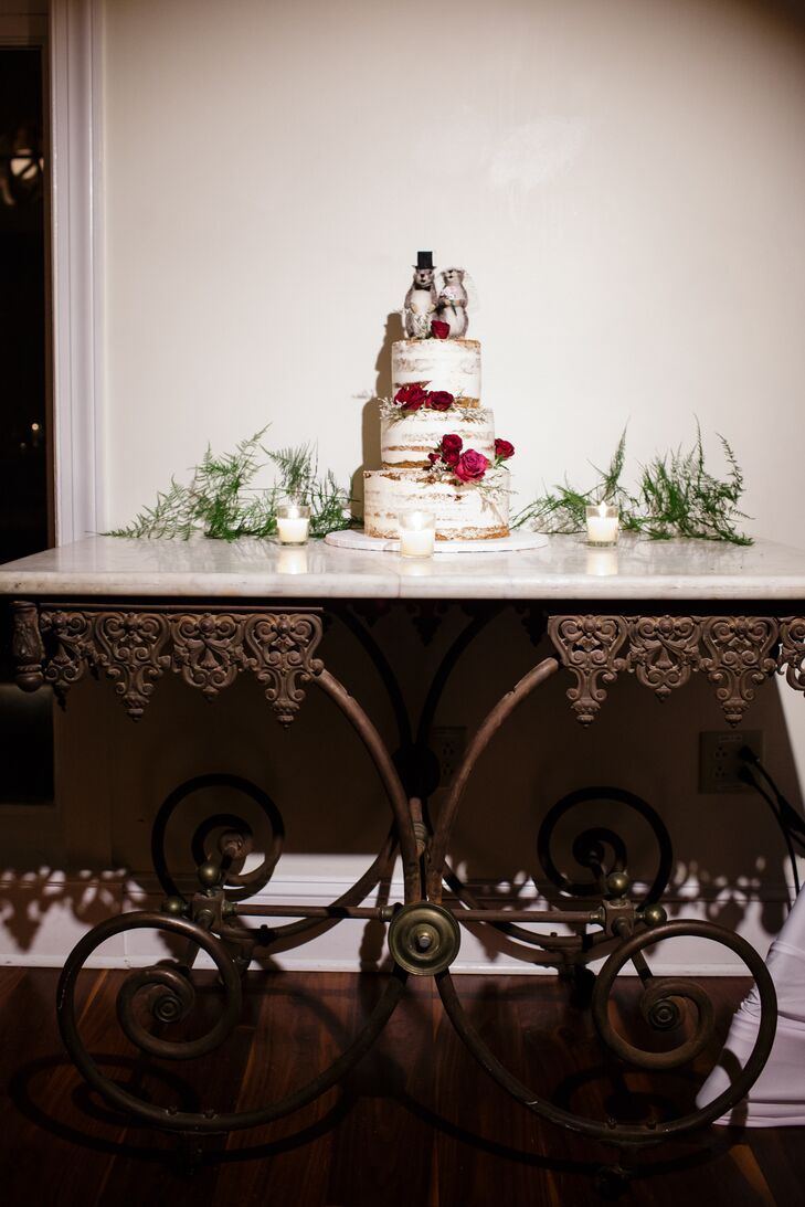 Their naked confection from Desserts by Dana was completely original. The three-tier vanilla, chocolate and almond wedding cake was separated with buttercream frosting and topped with red roses. Evergreen leaves and tealight candles circles the base, but what really caught our attention was the topper. They took bride-and-groom-inspired squirrel figurines and placed them on top of the cake. Now that's something we didn't expect!