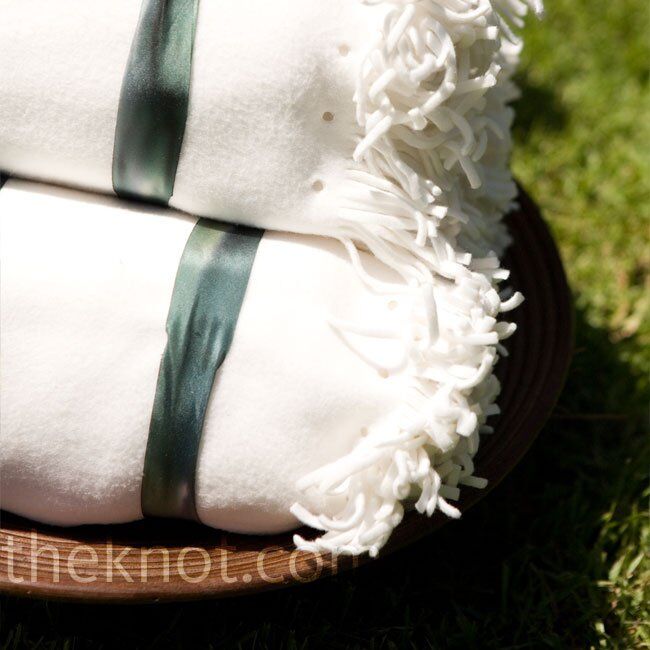 Even though the weather was beautiful, the wedding took place close to the beach, so Courtney and Andrew set out blankets for guests to take in case they got chilly when the sun went down.