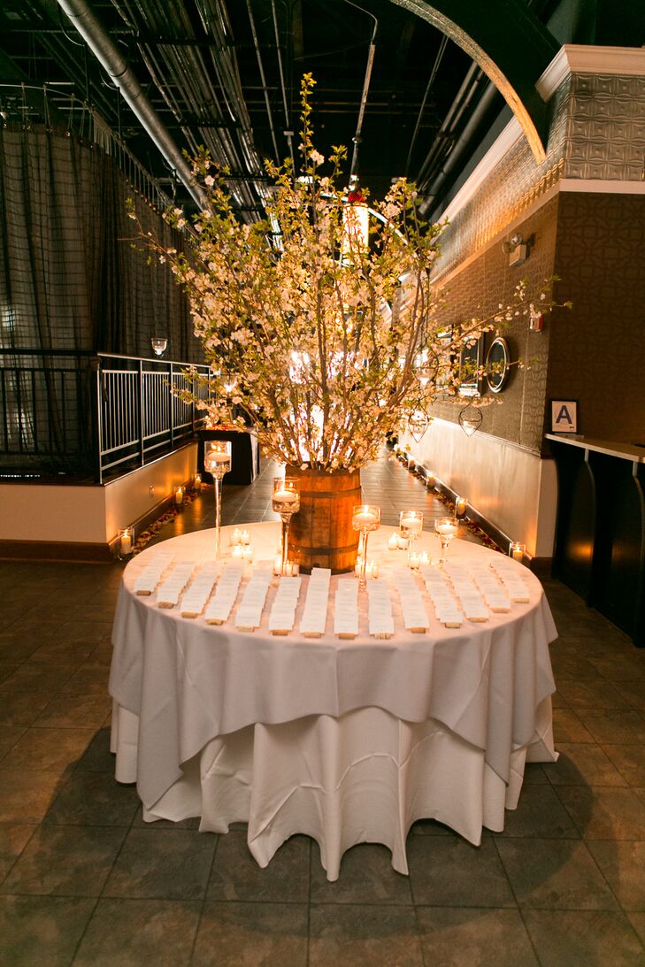 The escort card display table was decorated with a wine barrel from Terence's family with cherry blossom branches that was surrounded by floating candles.