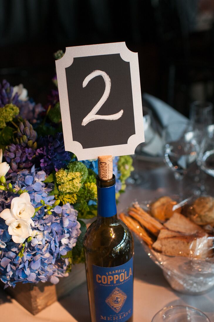 Table numbers were displayed on the cork stoppers of wine bottles on the reception tables.