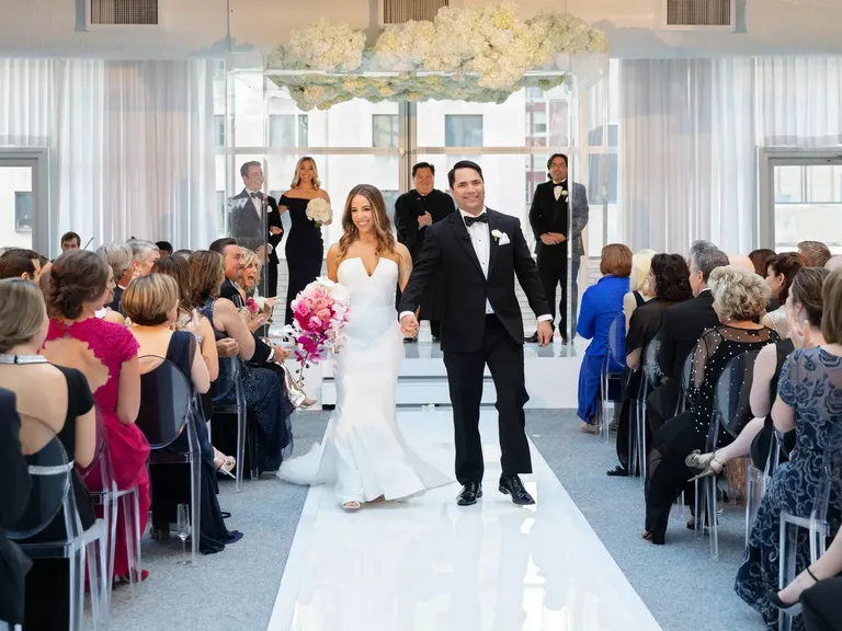 Couple walking down the aisle in modern indoor ceremony space at The Joule Hotel wedding venue in Dallas, Texas