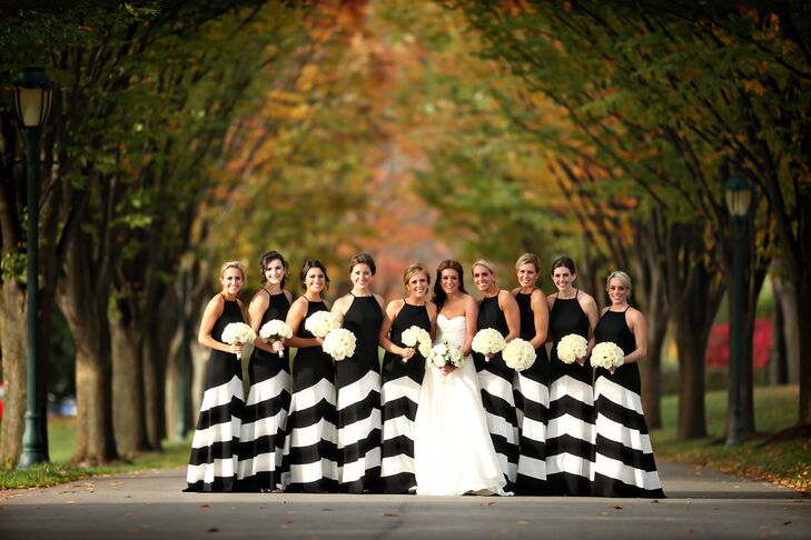 We love these unique bridesmaid dresses! Kieran's bridesmaids wore black floor-length dresses that featured graphic white chevron stripes and halter necklines. Together, the bridesmaids made a bold statement and added a modern edge to the classic wedding while still adhering to the black-and-white color palette.