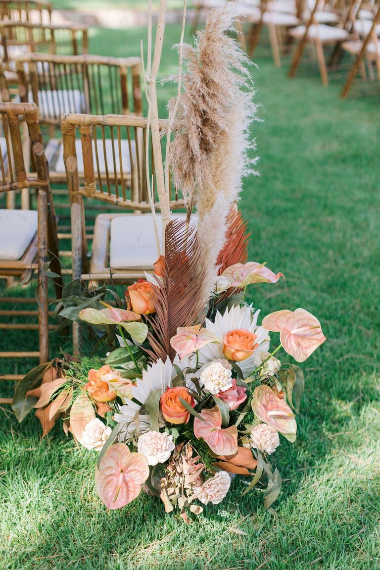 Aisle arrangement with orange anthurium and pampas grass