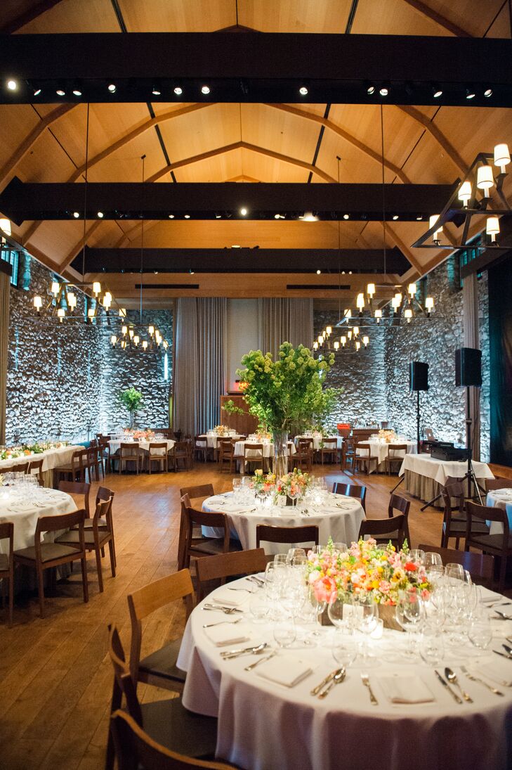 After cocktails in the courtyard, Alice and Stephen joined their gusts in the Hayloft Barn for dinner and dancing. “Since the venue is already so beautiful, there wasn't much needed from us in terms of decoration,” Alice says. Ivie Joy Flowers created arrangements for each table, alternating between skyward-reaching bouquets of green hydrangeas to distressed wooden planters filled with bright yellow, pink and orange blooms.