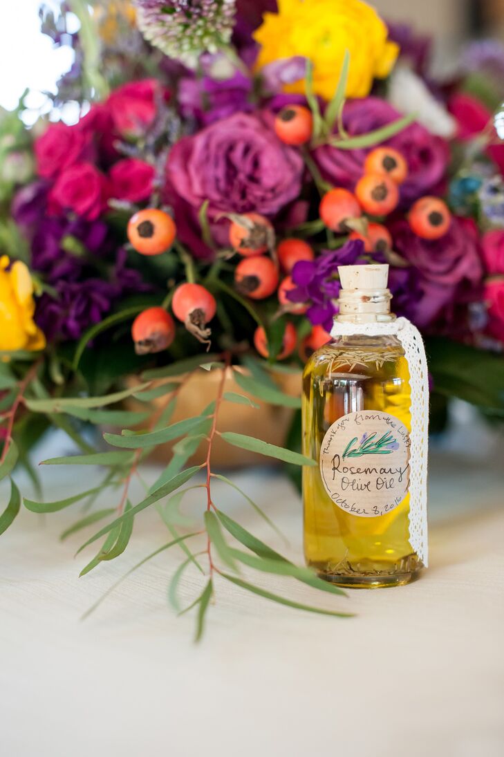 Tables were topped with colorful floral centerpieces in fuchsia, yellow and plum. Guests were given homemade rosemary olive oil in corked glass bottles with personalized stickers.