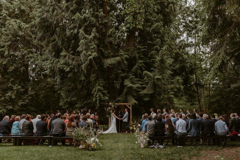 Couple holding hands during their wedding ceremony.