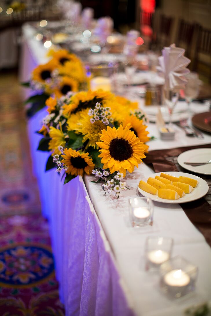 Flowers at the reception included arrangements sunflowers, small white daisies and bright yellow spider chrysanthemums at the head table.