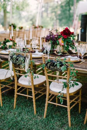 Gold Chiavari Chairs With Wild Greenery and Signs