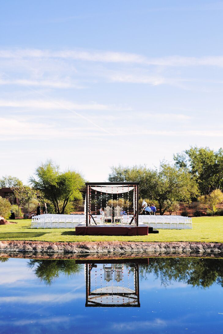 Family and friends helped hand-string the draped carnation curtain surrounding the wedding mandap, representing a temple. The four-pillar canopy and raised platform is a universal component of Hindu weddings.
