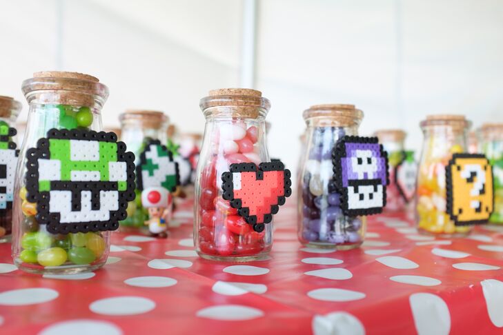 Small clear jars with colorful jellybeans and classic power-up perlers glued on the outside of the jar were given to guests as a unique, sweet treat.