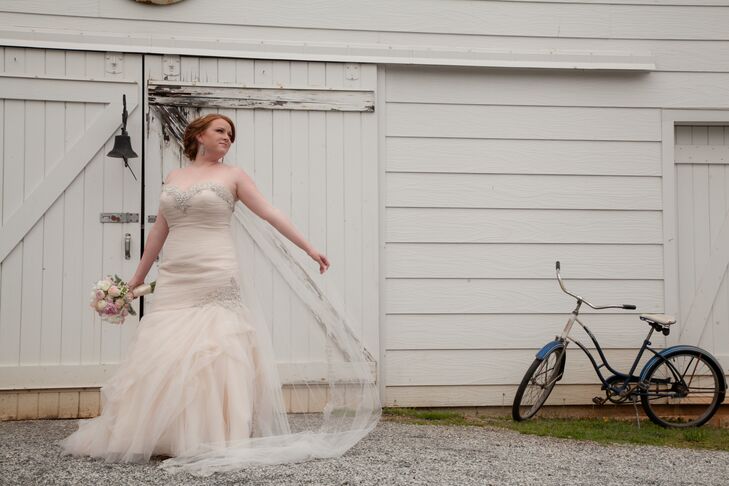 A cream cathedral length veil with lace edging completed Lindsey completed's romantic wedding look.