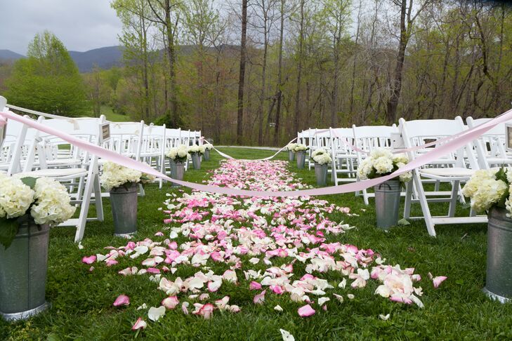 The couple walked down a homemade aisle of pale pink rose petals before exchanging vows during an outdoor ceremony in front of the ruins.