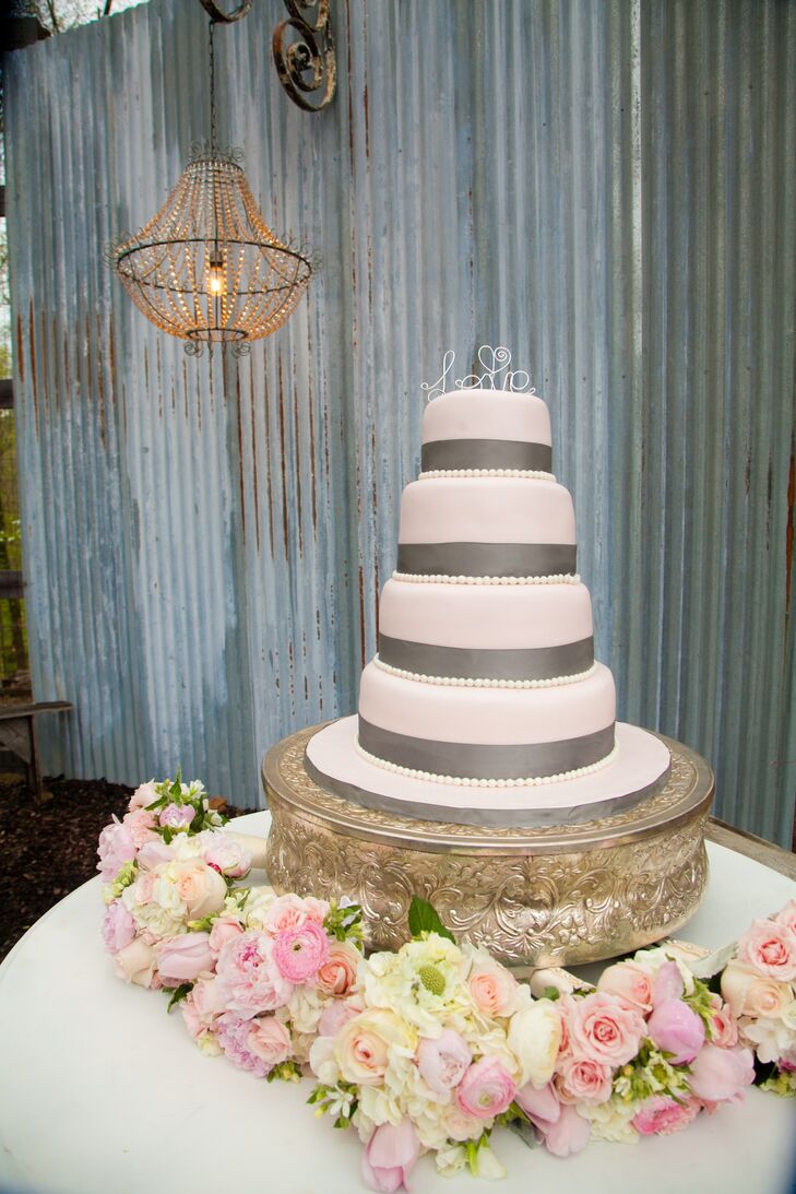 Smooth pink fondant with steel gray accents covered the four-tiered vanilla buttercream cake.