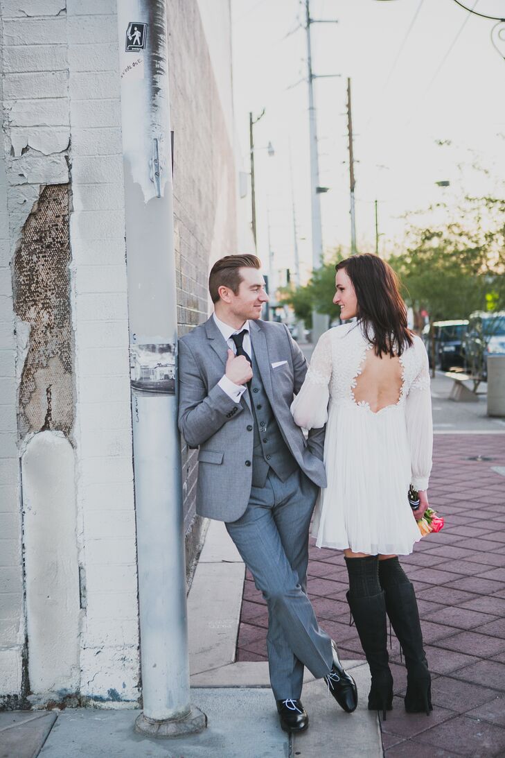 Livia wore a short white dress with a keyhole back with tall black boots and knee-high socks for a vintage, bohemian look.