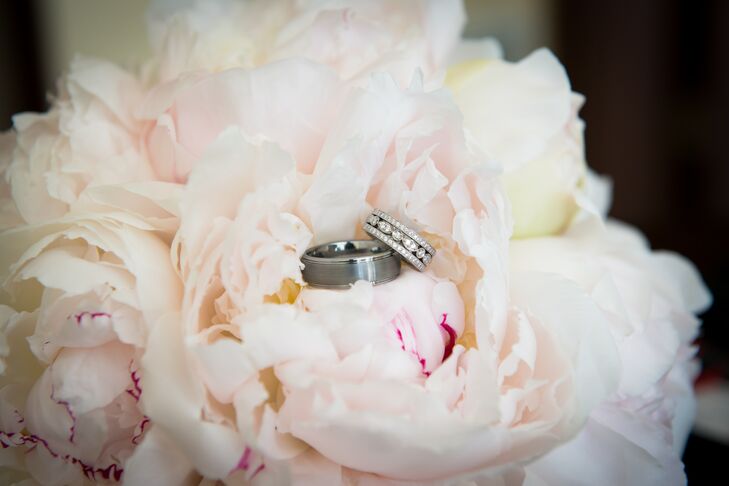 Wedding Rings Resting on White Peonies Bridal Bouquet