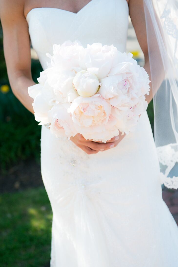 Nicole's Maggie Sottero wedding dress was a slim A-line gown in ivory with a lace overlay and corset back.