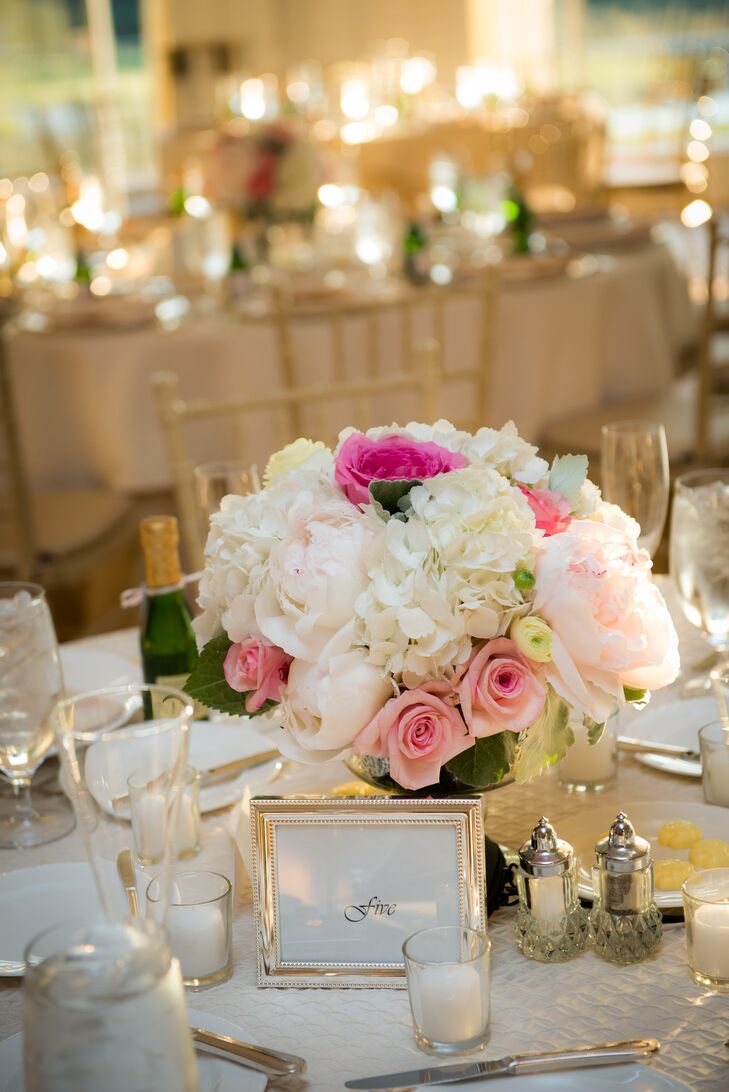 Some tables highlighted the candles with large pillar vases while others highlighted the flowers with a large vase and several small votive candles.