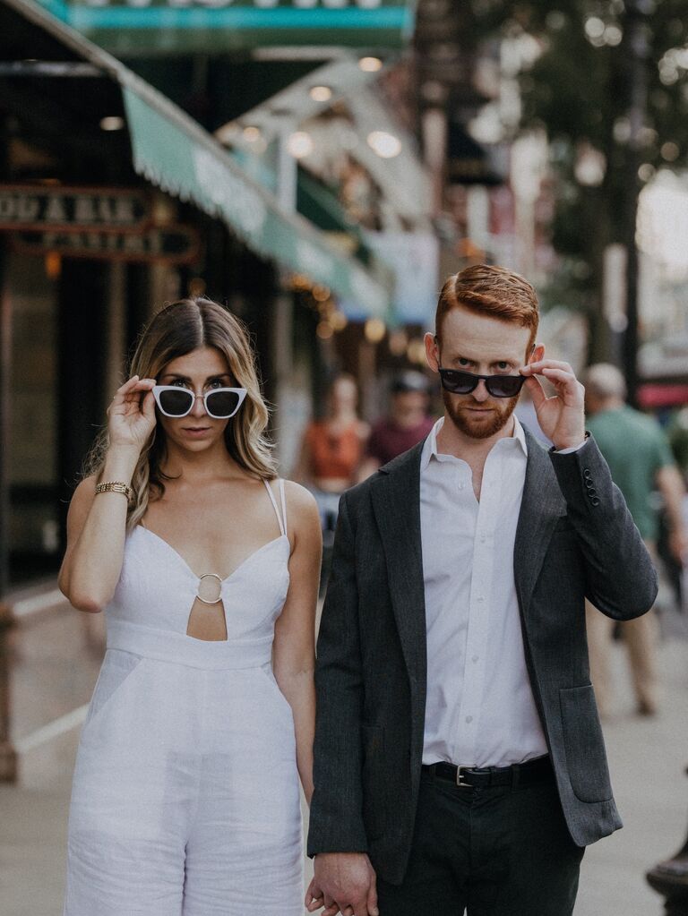 Couple poses with funky sunglasses. 