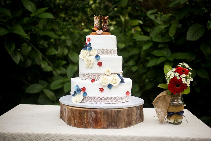 Ashley and Jason chose a three tier white confection decorated with red, white and blue fabric flowers, burlap and lace. It was composed of chocolate fudge cake and topped with "hisrnand hers" cowboy boots.