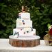 Ashley and Jason chose a three tier white confection decorated with red, white and blue fabric flowers, burlap and lace. It was composed of chocolate fudge cake and topped with "hisrnand hers" cowboy boots.