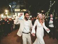 Bride and groom walking through sparkler send off