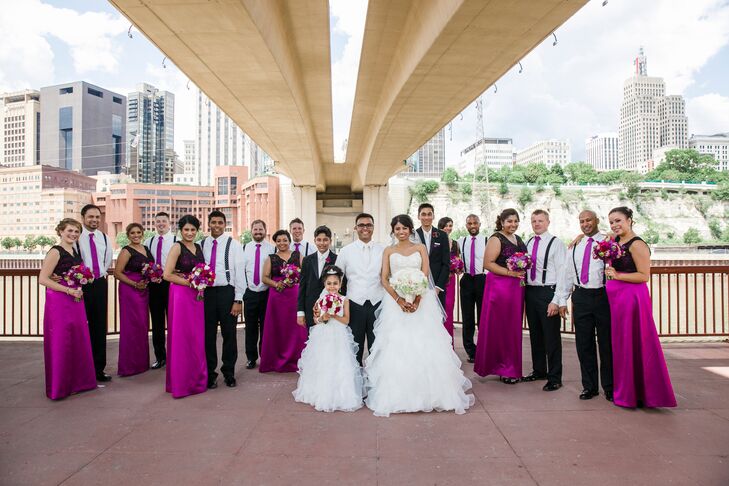 For the Western wedding reception at A'Bulae in St. Paul, Minnesota, the bridesmaids donned black lace and plum satin dresses from the Dessy collection. The groomsmen wore Michael Kors suits from Savvi Formalwear. The attire included white skirts, purple skinny ties, black slacks and suspenders.