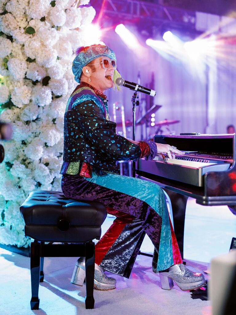 Sir Elton John signing at wedding reception