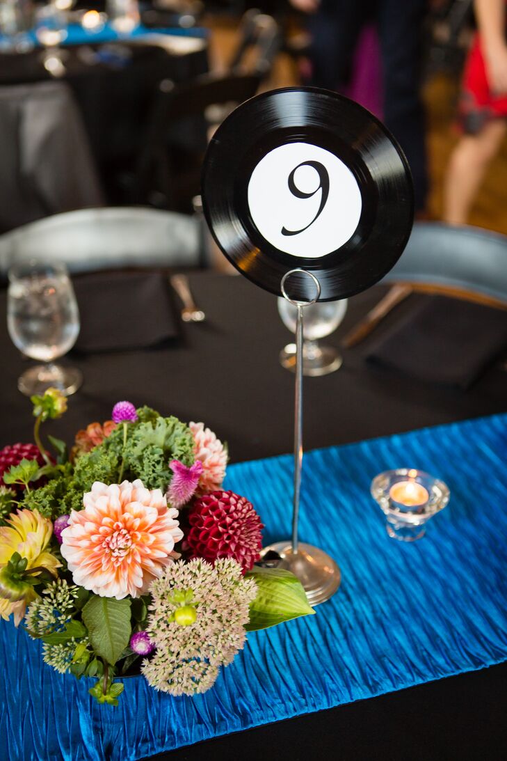 Anna and Brandon’s theme for their wedding was music, because it's such a big part of their lives. They had a DJ spin vinyl the whole night, and the table numbers were repurposed 45 rpm records.