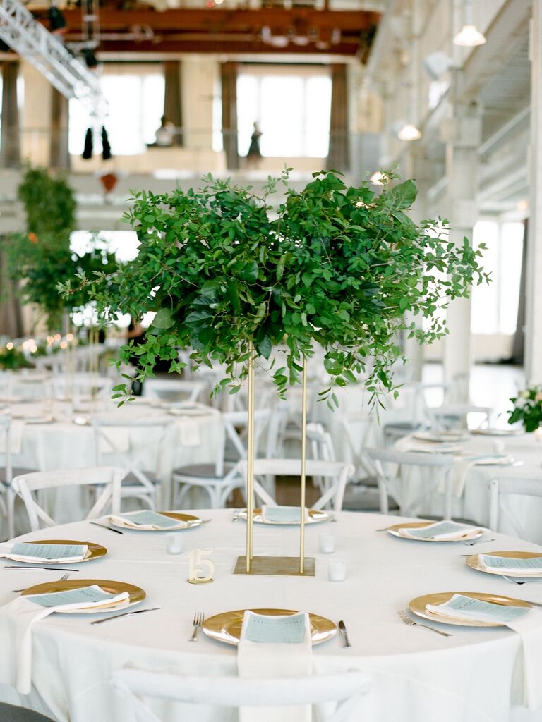 tall greenery wedding centerpiece with gold stand